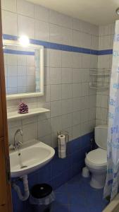 a blue and white bathroom with a sink and a toilet at 4 Seasons Villas 2 in Neokhórion