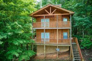 a wooden cabin in the middle of the woods at Suite Sensations in Pigeon Forge