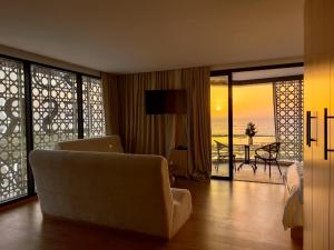 a living room with a couch and a view of the ocean at Les Roches De Mazagan in El Jadida