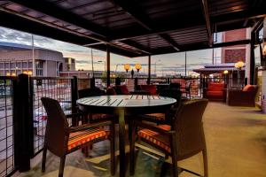 a patio with a table and chairs on a balcony at Hilton Garden Inn Lincoln Downtown/Haymarket in Lincoln