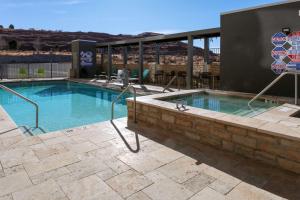 a large swimming pool with a brick wall at Home2 Suites By Hilton Page Lake Powell in Page