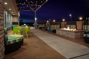 a patio with a table and chairs and a fire pit at Home2 Suites By Hilton Page Lake Powell in Page