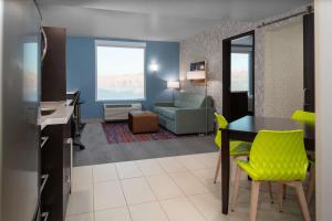 a living room with a table and yellow chairs at Home2 Suites By Hilton Page Lake Powell in Page