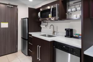 a kitchen with a sink and a microwave at Home2 Suites By Hilton Page Lake Powell in Page