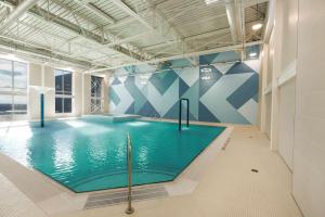 a large swimming pool in a large room with at Hilton Niagara Falls/ Fallsview Hotel and Suites in Niagara Falls