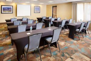 a conference room with tables and chairs and a screen at Hampton Inn & Suites Lancaster in Lancaster