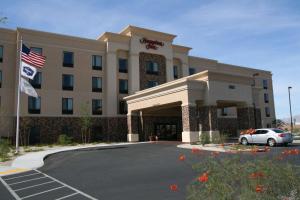 a hotel with a car parked in a parking lot at Hampton Inn Las Vegas/North Speedway in Las Vegas