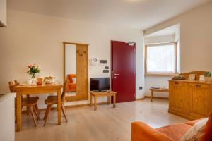 a living room with a table and a dining room at Residenza Casale in Comano Terme