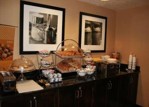 a buffet with bread and other food on a counter at Hampton Inn Salt Lake City/Murray in Murray