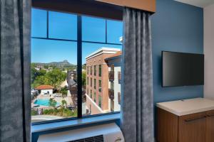 a room with a large window with a view at Hilton Garden Inn Prescott Downtown, Az in Prescott