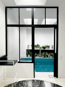 um quarto com vista para uma piscina através de uma janela em Loft House, Pool & Garden em Montreuil