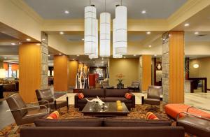 a lobby of a hotel with couches and chairs at DoubleTree by Hilton Hotel St. Louis - Chesterfield in Chesterfield