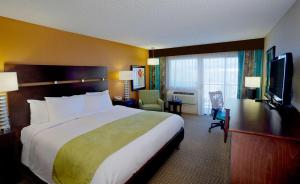 a hotel room with a large bed and a television at DoubleTree by Hilton Santa Fe in Santa Fe