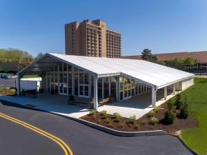 a large building with a white roof in a parking lot at DoubleTree by Hilton Hotel St. Louis - Chesterfield in Chesterfield