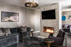 a living room with a couch and a fireplace at LondonHouse Chicago, Curio Collection by Hilton in Chicago