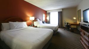 a hotel room with two beds and a flat screen tv at Hilton Garden Inn Secaucus/Meadowlands in Secaucus