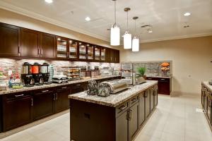 a large kitchen with wooden cabinets and granite counter tops at Homewood Suites by Hilton Palo Alto in Palo Alto