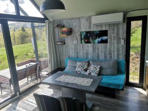 a living room with a blue couch and a table at Pod Gwiazdami in Cisna