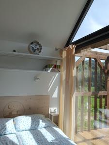 a bedroom with a bed and a large window at Pod Gwiazdami in Cisna