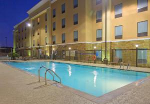 a swimming pool in front of a building at night at Hampton Inn & Suites New Braunfels in New Braunfels