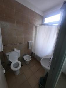 a bathroom with a toilet and a sink at Real Splendid Hotel in Buenos Aires