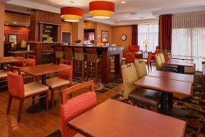 a restaurant with tables and chairs and a bar at Hampton Inn Litchfield in Litchfield