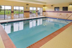 a large indoor swimming pool with blue water at Hampton Inn Litchfield in Litchfield