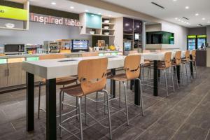 a cafeteria with a white table and chairs at Home2 Suites By Hilton Rowlett Rockwall Marina in Rowlett