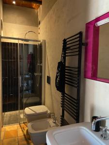 a bathroom with a toilet and a sink and a shower at B&B Molino2Rosso in Verona
