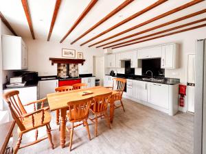 a kitchen with a wooden table and chairs at Bridge House in Muker