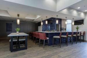 a lobby with a bar with chairs and a kitchen at Hilton Garden Inn Elkhart in Elkhart