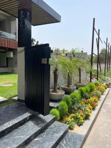 a garden with a black fence and flowers at Cyber Vista in Gurgaon