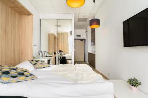 a bedroom with a large white bed with pillows at ShortStayPoland Aleje Jerozolimskie in Warsaw