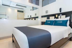 Un pat sau paturi într-o cameră la Hotel Kalu