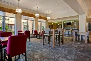 a restaurant with tables and chairs and a bar at Hilton Garden Inn San Bernardino in San Bernardino