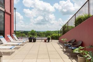 a patio with chairs and plants on a building at Hampton Inn Branson on the Strip in Branson