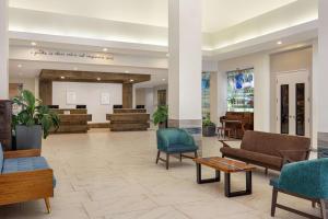 a lobby with couches and chairs in a hospital at Hilton Garden Inn South Padre Island in South Padre Island