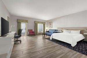 a hotel room with a bed and a tv at Hilton Garden Inn South Padre Island in South Padre Island