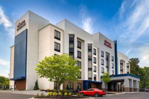 une voiture rouge garée devant un bâtiment dans l'établissement Hampton Inn & Suites Alpharetta Roswell, à Alpharetta