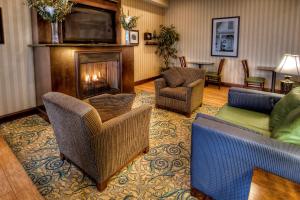 a living room with couches and a fireplace at Hampton Inn Roanoke Rapids in Roanoke Rapids