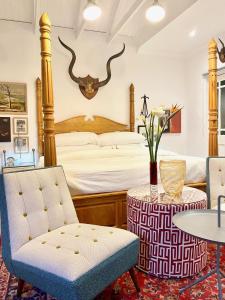 a bedroom with a bed with antlers on the wall at 1 Royal Street Guesthouse in Riebeek-Kasteel