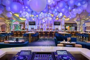 拉斯维加斯Crockfords Las Vegas, LXR Hotels & Resorts at Resorts World的一间装满紫色气球的房间和一间酒吧 更多37张照片