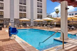 a pool at a hotel with chairs and umbrellas at Hampton Inn San Antonio Downtown in San Antonio