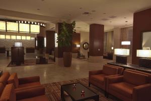 a lobby with couches and a table in a building at Embassy Suites Palmdale in Palmdale