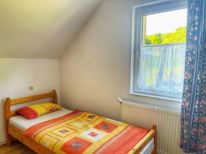een kleine slaapkamer met een bed en een raam bij Kati Guesthouse in Corund