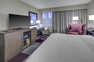 a hotel room with a bed and a flat screen tv at Hampton Inn Miami-Coconut Grove/Coral Gables in Miami