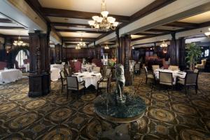 a restaurant with tables and chairs and a statue in the middle at The Seelbach Hilton Louisville in Louisville