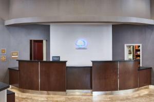 a waiting room with wooden counters in a building at Doubletree By Hilton Fullerton in Fullerton