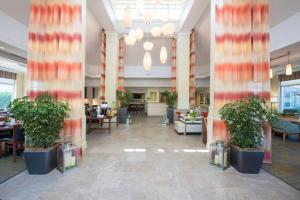 a lobby with potted plants in a building at Hilton Garden Inn Lexington in Lexington