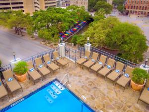 an aerial view of a hotel pool with chairs and trees at Hilton Palacio del Rio in San Antonio